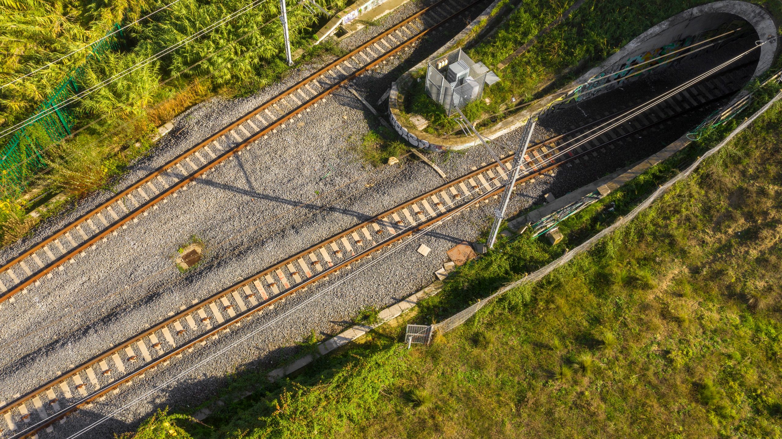 Aerial view of railway tracks running past a tunnel portal